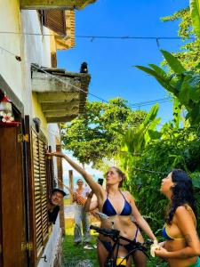 a group of women in bathing suits standing outside a building at Hostel Mawe in Paraty