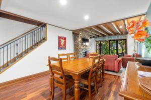 a dining room with a wooden table and chairs at Lansdown Apartments in Wanaka