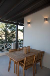 a wooden table and chairs on a patio at Siroa Serene in Rózia