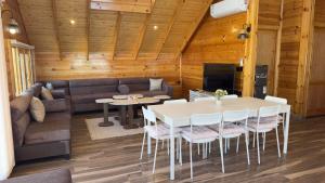 a living room with a couch and a table and chairs at اكواخ اليمامة in Al Baha
