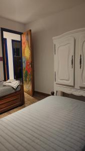 a bedroom with a bed and a dresser and a mirror at Casa Aguaribay- Lomas Altas- in Chascomús +25 photos