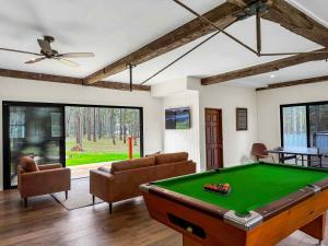 a living room with a pool table in it at Highwoods Cottage in Pokolbin