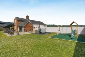 a yard with a playground and a house at 7 Bed in Welshpool oc-96412 in Berriew