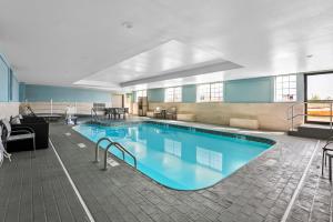 a large swimming pool in a hotel room at Holiday Inn Express Hotel & Suites Wabash by IHG in Wabash
