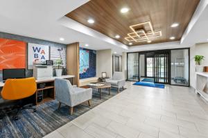 an office with chairs and a desk and a tv at Holiday Inn Express Hotel & Suites Wabash by IHG in Wabash