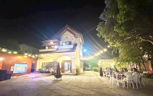 a group of people sitting in chairs in front of a building at Roll Huynh in Kon Plong