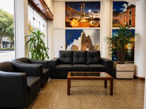 a living room with a couch and a coffee table at Oscar Hotel in Florianópolis