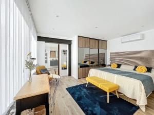 a bedroom with a bed and a desk and a room at Demeures du Bord de Seine in Samoreau +106 photos