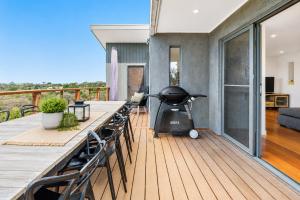 a grill on the deck of a house at Nautilus by Ready Set Stay in Rye