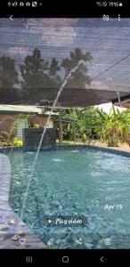 a water fountain in a swimming pool at Ranch-O-Tel Guesthouse and Event Center in Villasis
