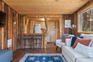 a living room with a couch and a table at Little Joy BHBungalows #4 in Custer
