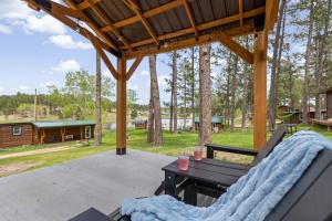 a patio with a bench and a table and a cabin at Little Joy BHBungalows #4 in Custer