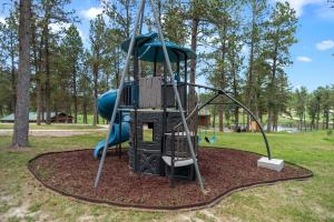 a playground with a slide in a park at Little Joy BHBungalows #4 in Custer