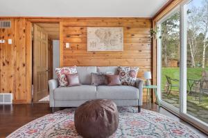 a living room with a couch and a large window at Hobbit Hole BHBungalows #3 in Custer