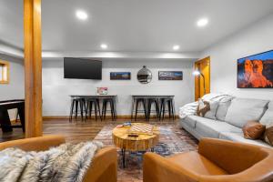 a living room with a couch and a table at Modern Lodge- BHBungalows Main in Custer