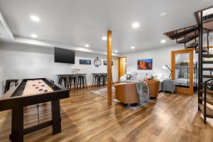 a living room with a pool table and a couch at Modern Lodge- BHBungalows Main in Custer +77 photos