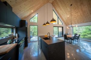 an open kitchen and dining room with a dining table at Chalet OSLO in Saint Come +45 photos
