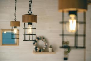 two chandeliers hanging in a room with a wall at ヌックベル in Kumamoto +36 photos