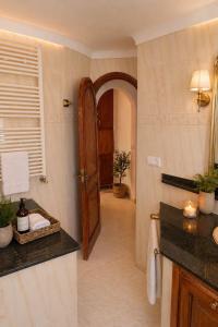 a bathroom with a sink and a door in a room at Excelente villa With pool ibiza in Santa Gertrudis de Fruitera +32 photos
