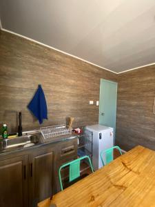 a kitchen with a sink and a table with chairs at Cielo Tiny House in San Pedro de Atacama +21 photos