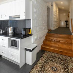 a kitchen with white cabinets and a counter top at Cape Nelson Lighthouse in Portland