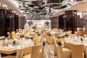 a banquet hall with tables and chairs and chandeliers at Crowne Plaza Xi'an by IHG in Xi'an +134 photos