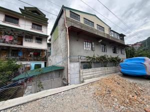a building with a blue tarp parked in front of it at RD's Apartment in Eyeb, Poblacion, Bontoc in Bontoc +9 photos