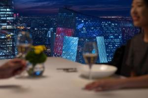 a couple of people sitting at a table with wine glasses at Park Hyatt Beijing in Beijing
