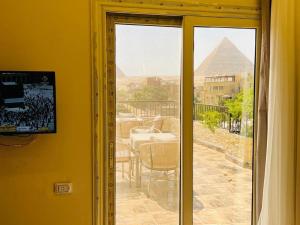 a door to a patio with a view of the pyramid at House Pyramids View Hotel in Cairo