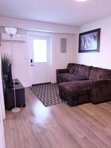 a living room with a couch and a television at Stay with Silvia in Halifax