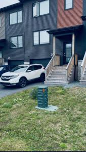 a white car parked in front of a house at Stay with Silvia in Halifax