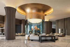 a lobby with a large painting on the wall at Manado Marriott Resort & Spa in Manado