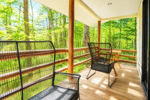 a screened in porch with two chairs on it at rinne 北軽井沢 Forest3 in Tsumagoi