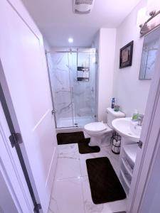 a bathroom with a shower and a toilet and a sink at Stay with Silvia in Halifax +12 photos