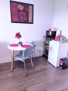 a dining room with a table and chairs and a refrigerator at Stay with Silvia in Halifax