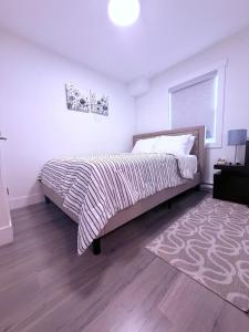 a bedroom with a large bed and a rug at Stay with Silvia in Halifax