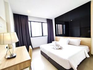 a hotel room with a large bed and a desk at Genting MujiColdInn2R2B AT Ion Delemen in Genting Highlands +42 photos
