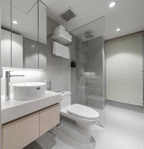 a bathroom with a toilet and a sink and a shower at Little Charm Boutique Hotel in Hanoi +149 photos