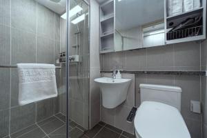 a small bathroom with a toilet and a sink at Bella Stay in Chuncheon