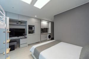 a bedroom with a large bed and a television at Bella Stay in Chuncheon +44 photos