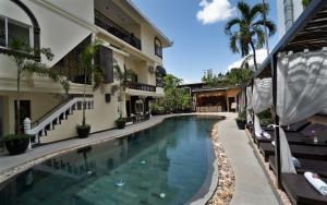 a swimming pool in front of a building at The Palace Indochine Hotel in Siem Reap