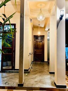 a hallway with a wooden door and a chandelier at Luna Mara in Arugam Bay