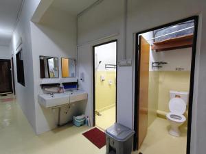 a bathroom with a sink and a toilet and a mirror at Sleepy Bear Capsule Hostel in Johor Bahru