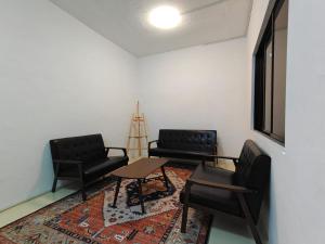 two chairs and a table in a room at Sleepy Bear Capsule Hostel in Johor Bahru +27 photos