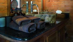 a bathroom counter with a sink and towels at HIDDEN HEAVEN Rumah Barong in Jasri +134 photos
