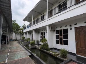 a building with a river in front of it at Nata Hotel Tasikmalaya in Gunungcupu