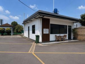 a building with a table in a parking lot at Nata Hotel Tasikmalaya in Gunungcupu
