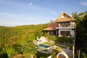 an aerial view of a house with a swimming pool at Villa Treetop, 2BR with spectacular ocean view in Nusa Penida