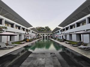a swimming pool in the middle of a building at Kuta Living in Kuta