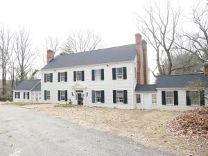 a large white house with two chimneys and a driveway at walnutwood in Owings Mills